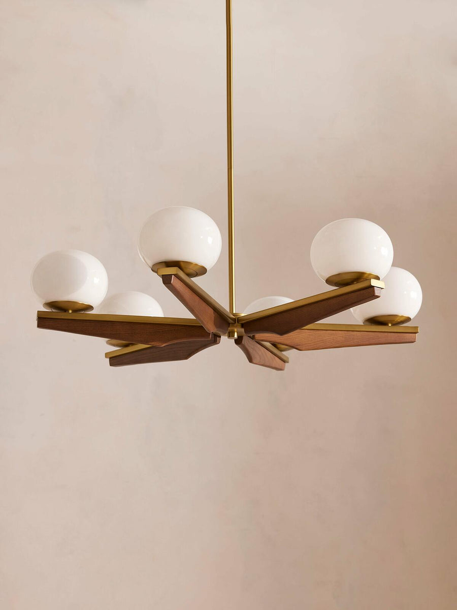 Demarco chandelier by Soho Home. Antique brass details, chandelier features six oval glass orbs, solid oak. Mid century inspired. Inspired by Soho House.