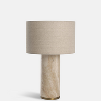 Remi Table Lamp, Large by Soho Home. Crafted from solid travertine, brass detailing and a natural linen shade. Inspired by Soho House.